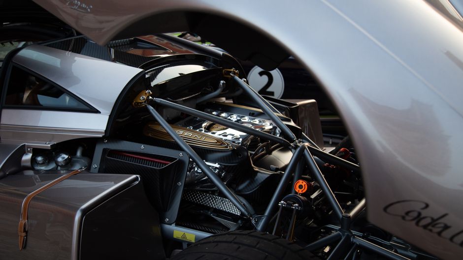 Close-up of the intricate engineering details in a Pagani hypercar engine bay.